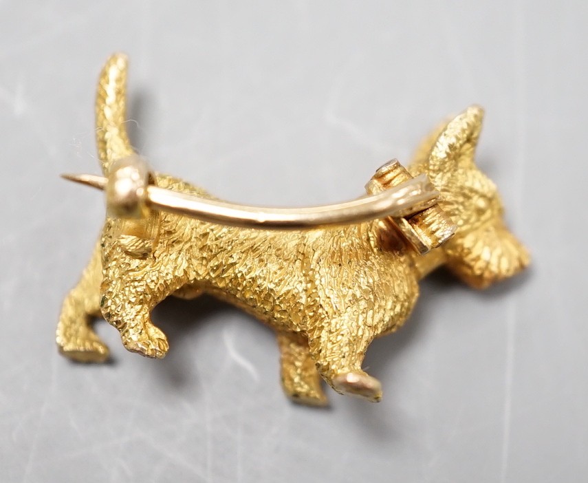 A textured yellow metal Scottie dog brooch, 24mm, 8 grams.